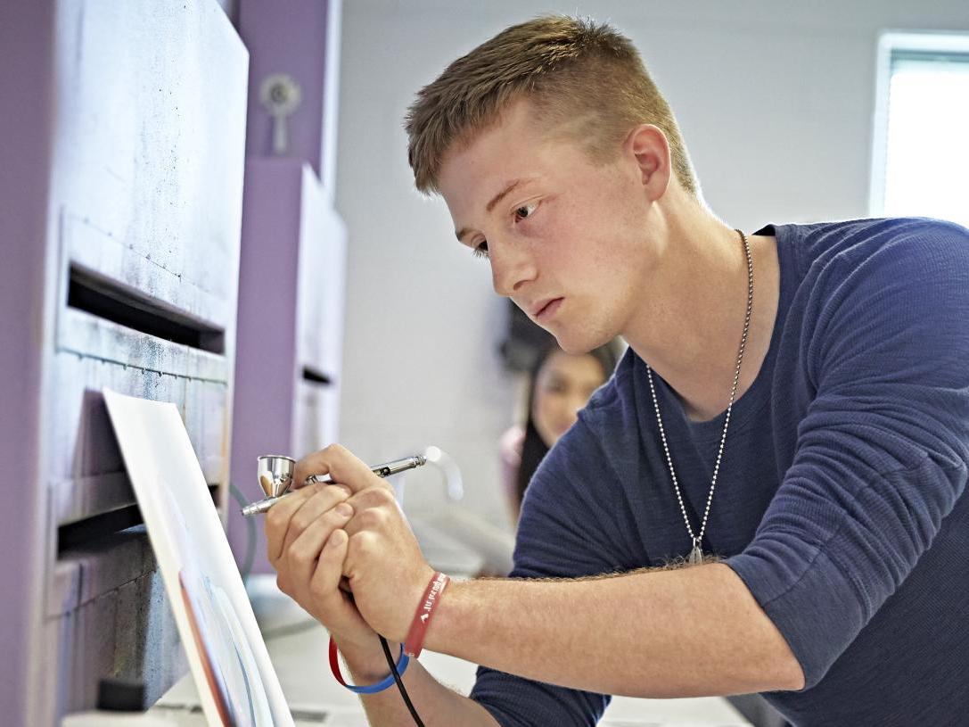 A VPA student practices airbrushing in a design lab